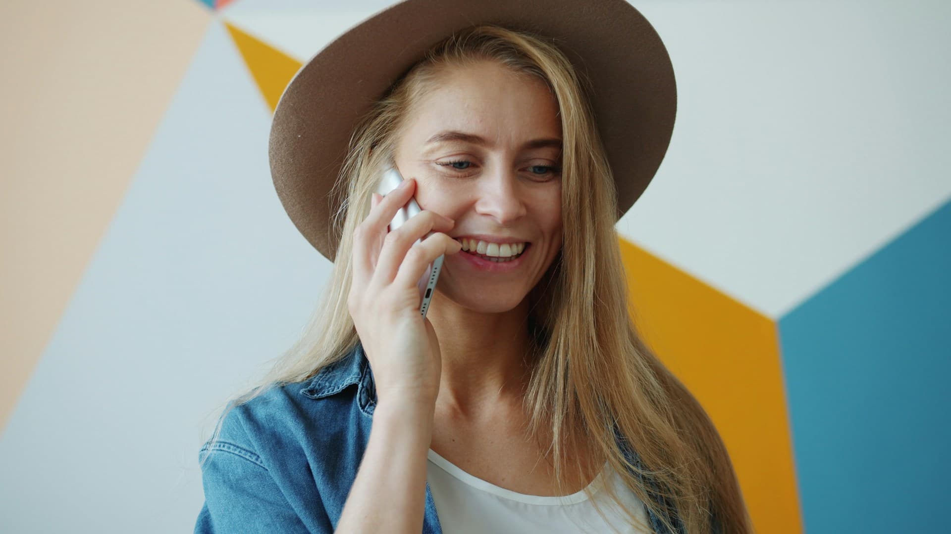 A woman calling on a phone and smiling